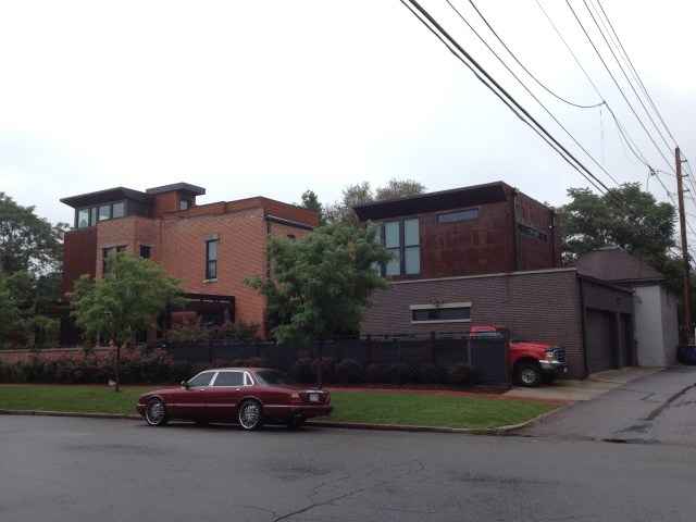 A cool house with a nice Rakish Jag out front on the street